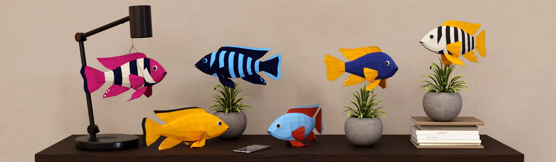 Low-poly African Cichlid paper craft models in bright colors displayed on sideboard as creative fish décor