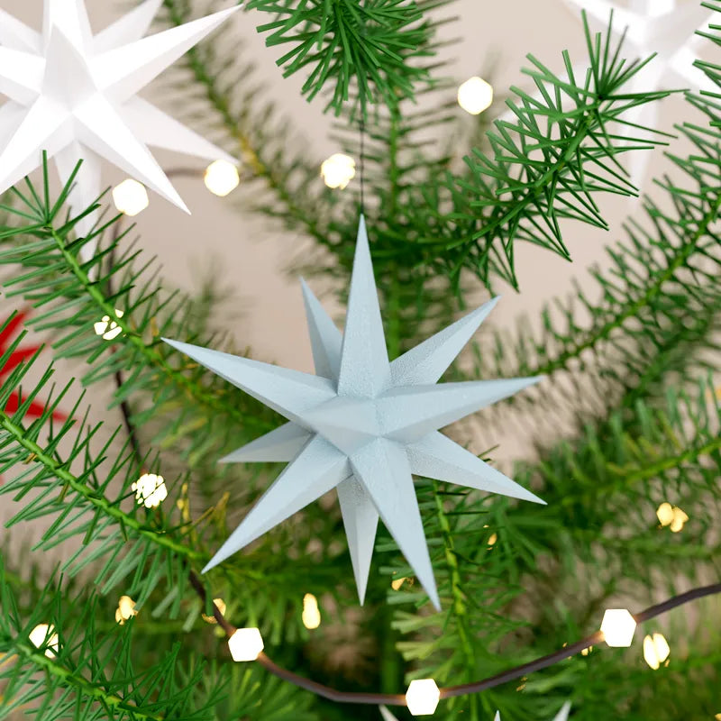 Detail of a hanging Christmas Snowflake crystal ornament on a tree.