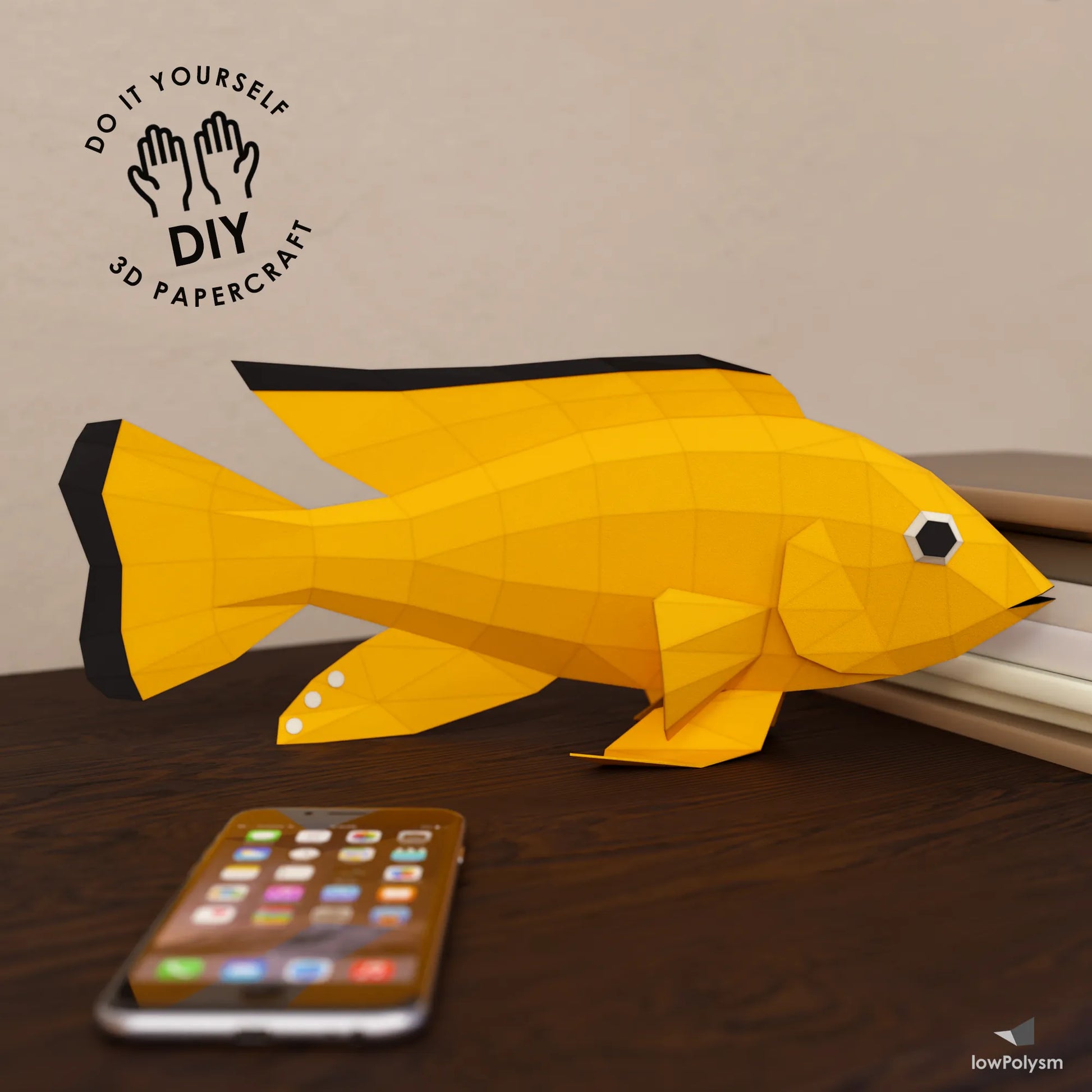 DIY Yellow Lab Cichlid 3D paper craft model in low poly design on a table.