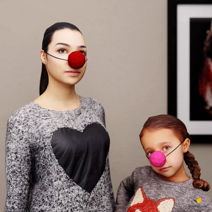 Woman and child wearing a large red and pink papercraft DIY clown nose masks