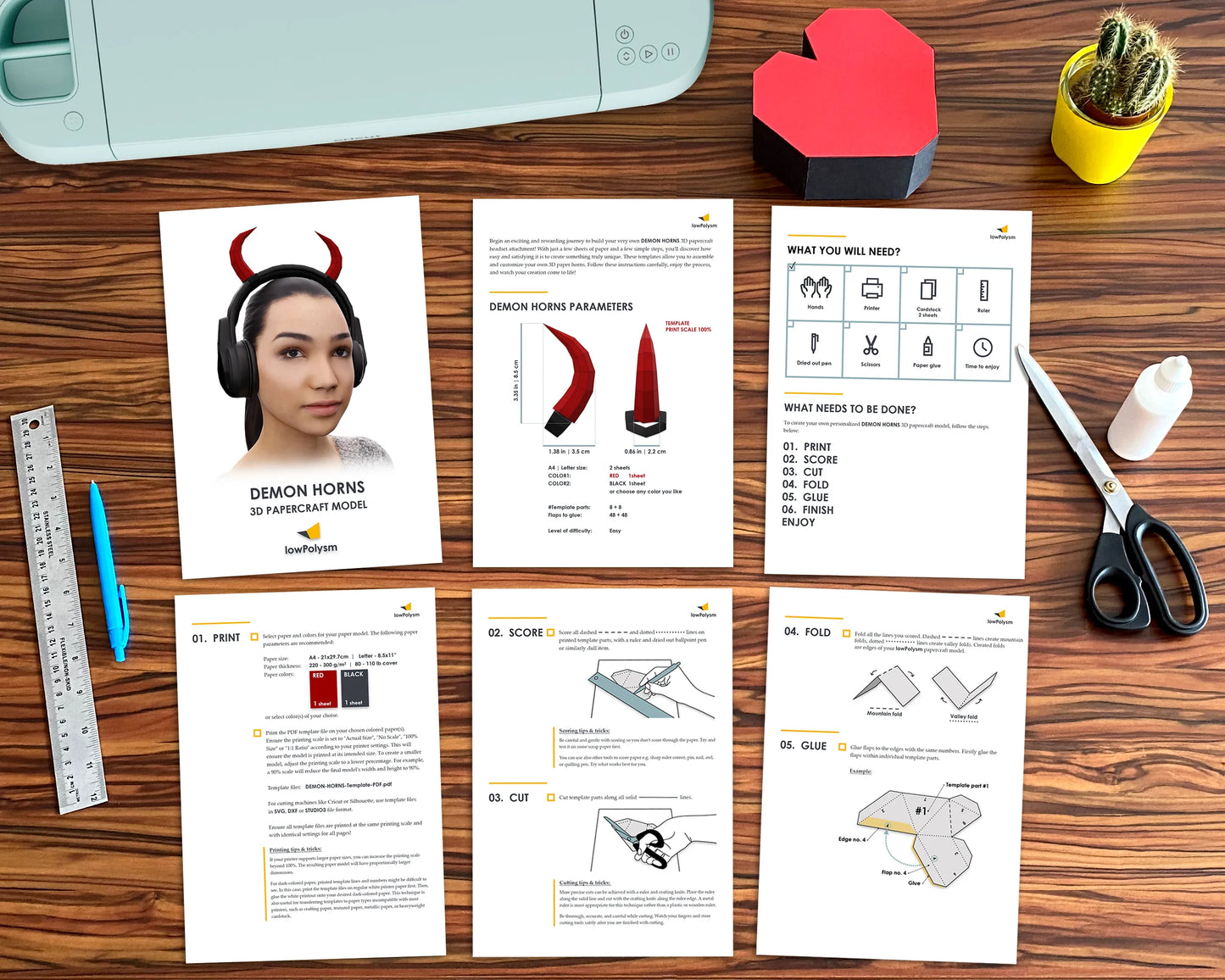 Flat lay showing the printed assembly guide, paper templates, and tools for the DIY horns headset project.
