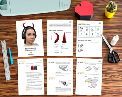 Flat lay showing the printed assembly guide, paper templates, and tools for the DIY horns headset project.