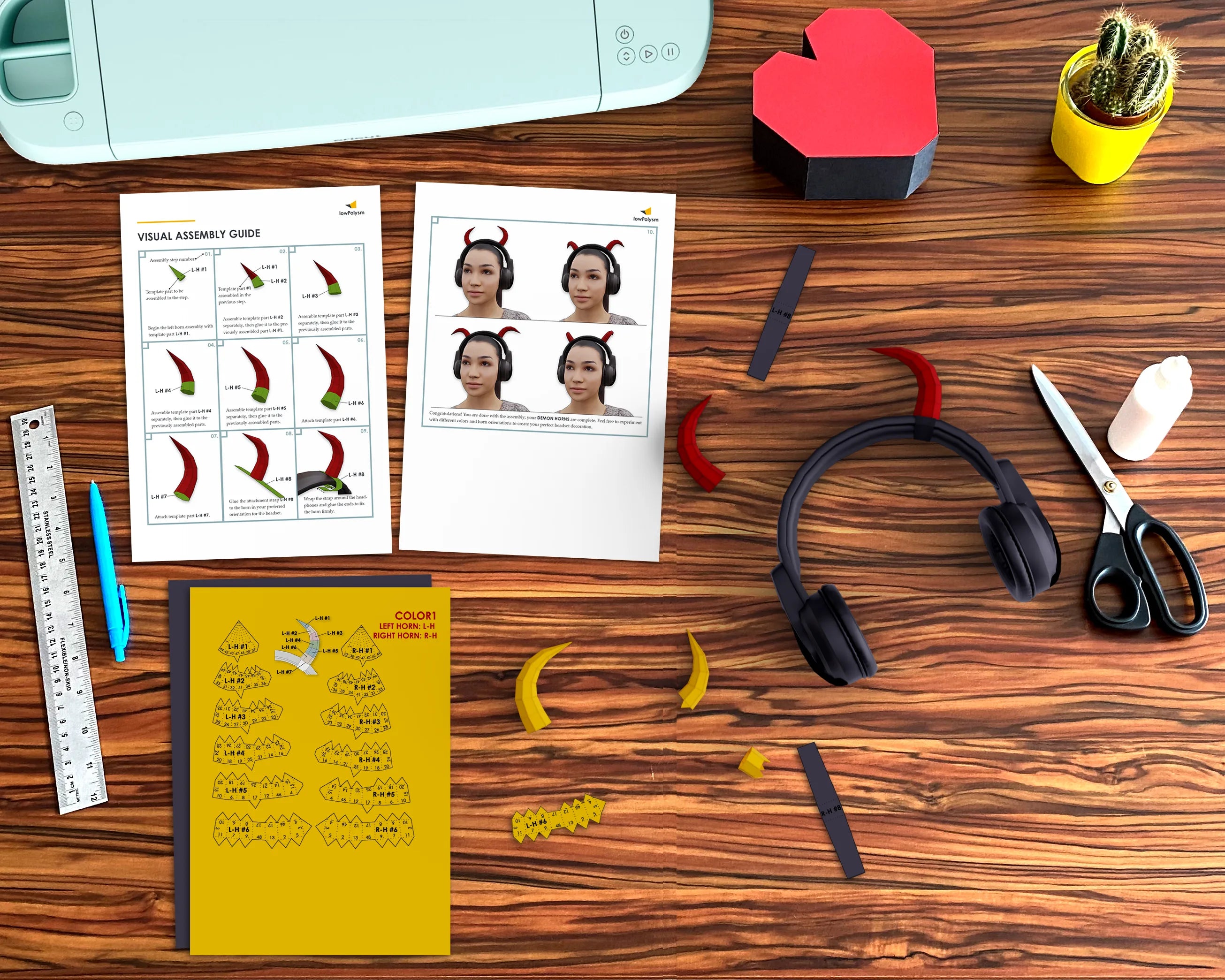 Crafting workstation with a completed headset mod, 3D papercraft demon horns, and assembly instructions.
