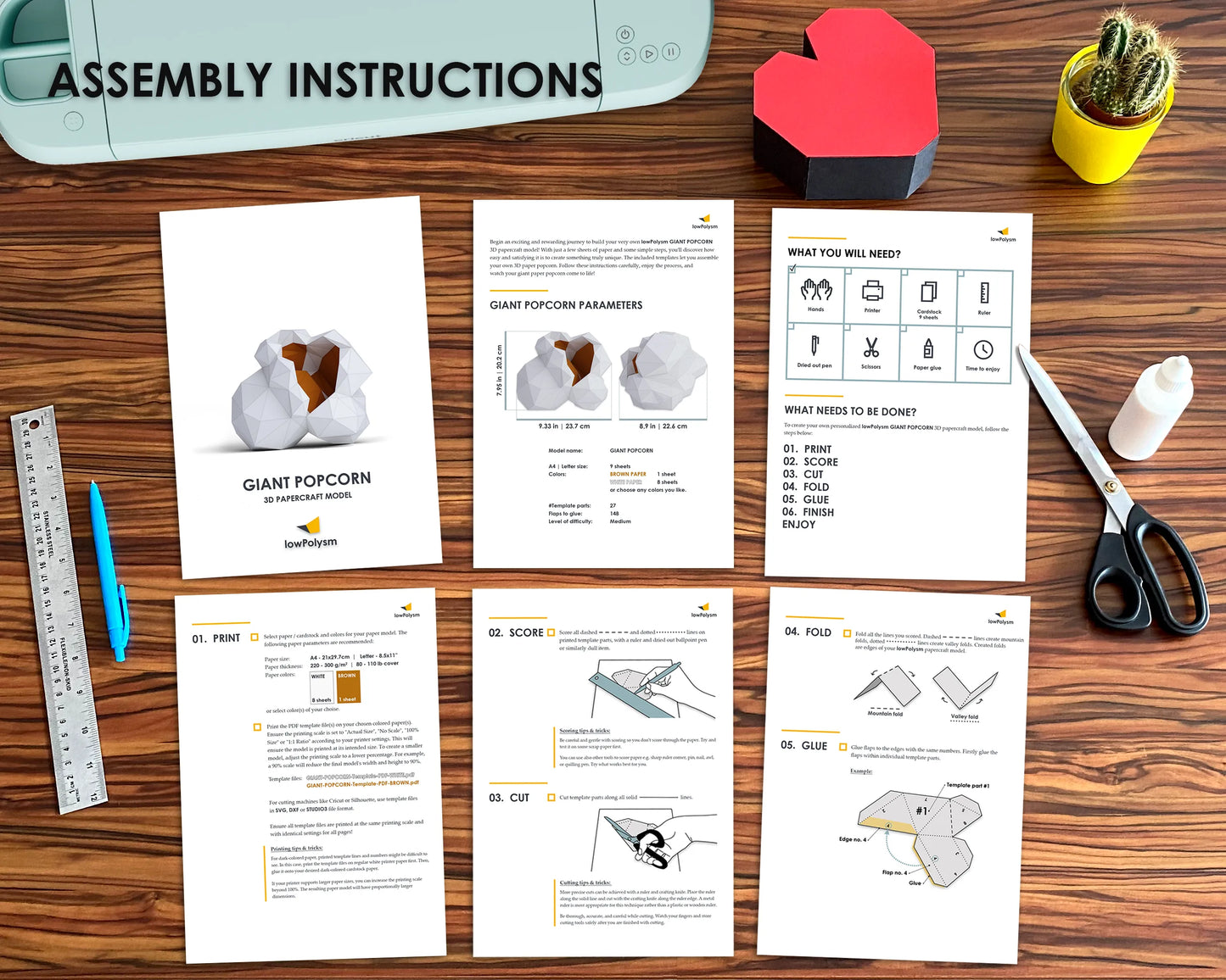 Assembly instructions for a giant popcorn model on a wooden table with scissors, cricut machine and a cactus.