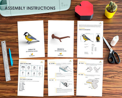 Bird paper craft printed assembly instructions on table