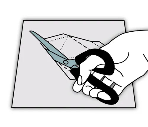 Hand with scissors cutting the template
