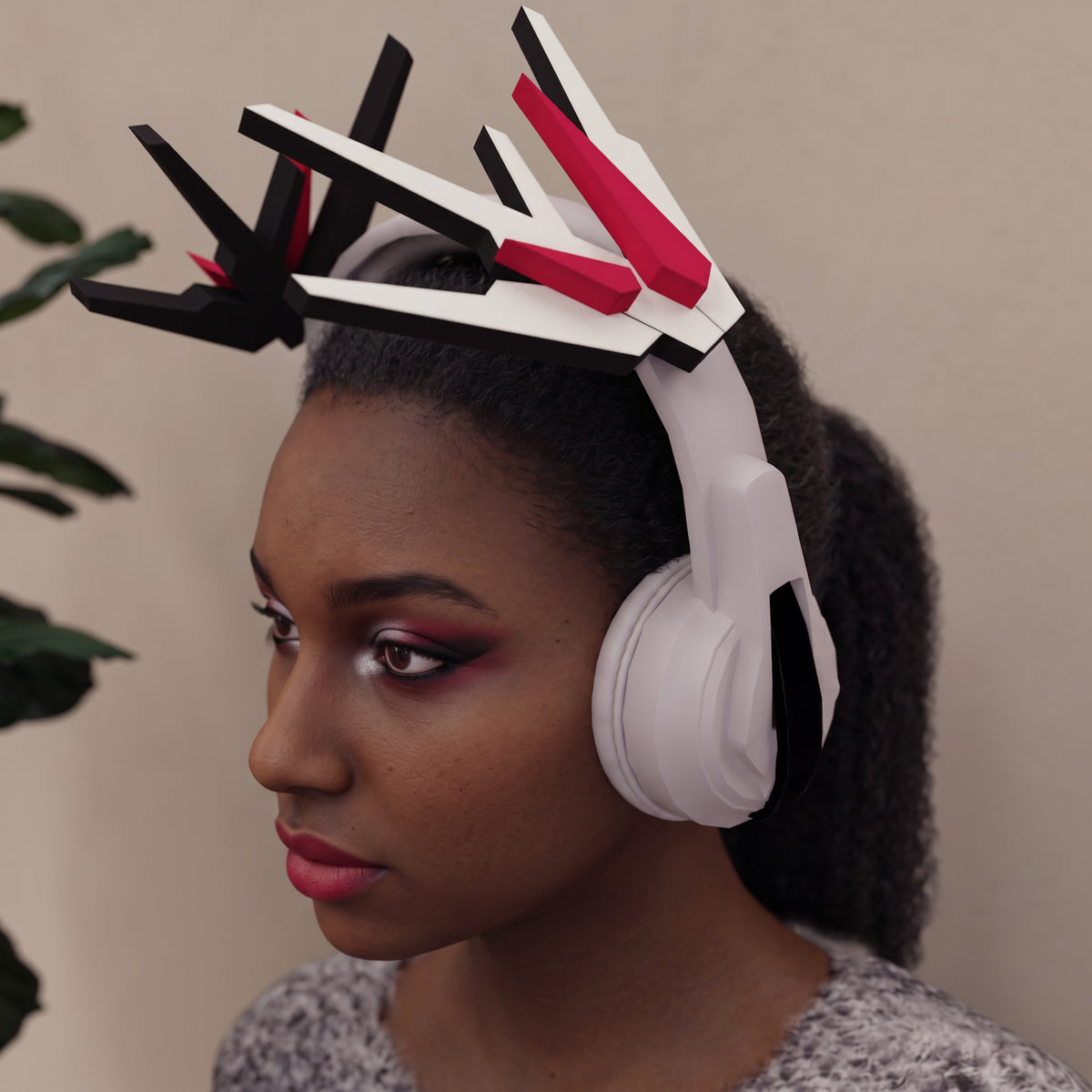 DIY papercraft mecha wings attached to gaming headset on white headset with pink crystals.