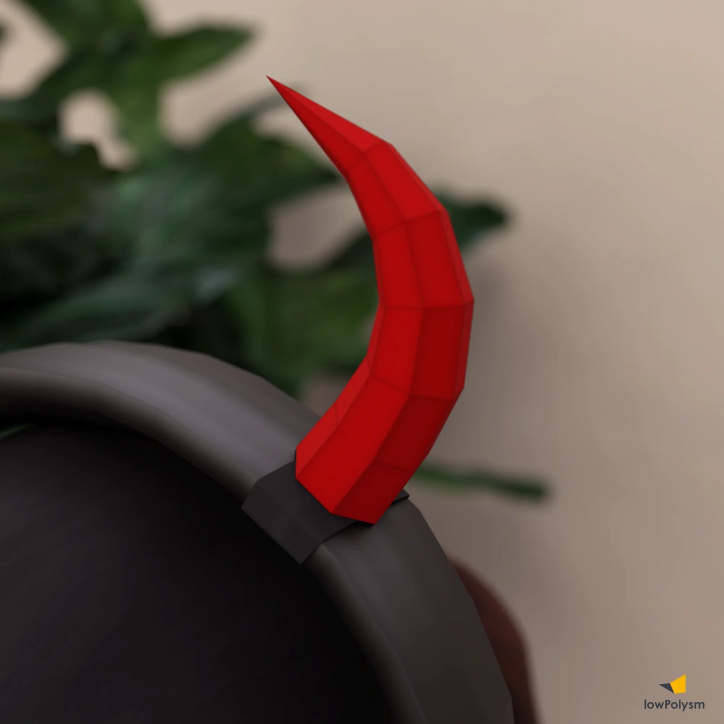 Close-up detail of a red 3D papercraft demon horn securely attached to a headset headband.