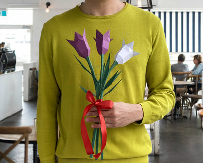 A person holding a handmade bouquet of purple and white paper bellflowers with a red ribbon, presented as a unique DIY gift.